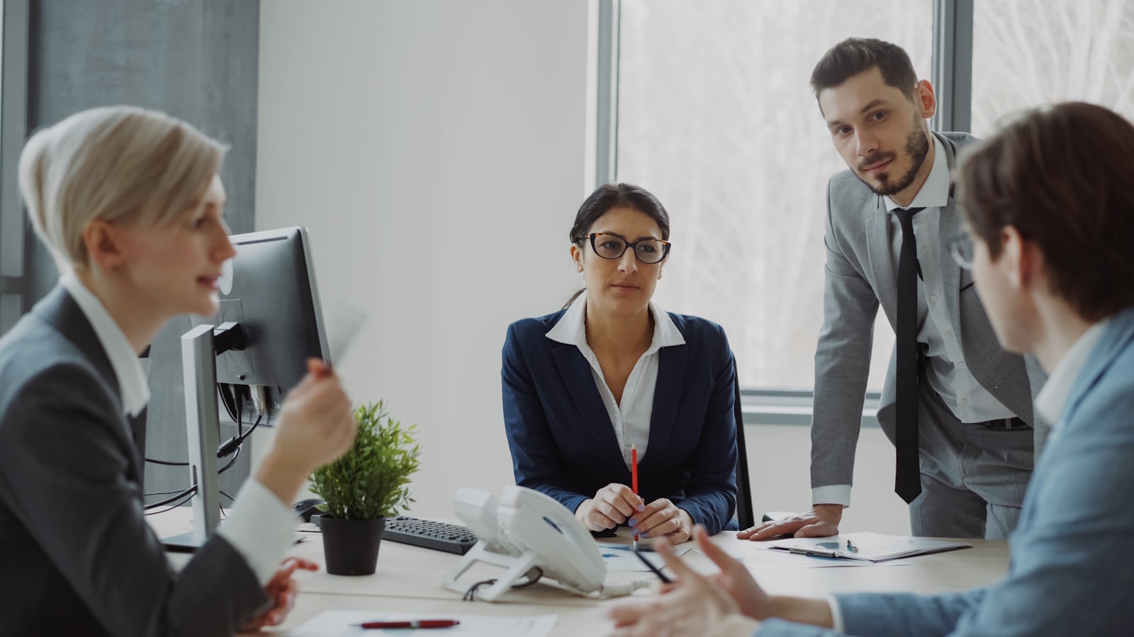 UK Sure insurance team collaborating in a modern office to find customers the right cover